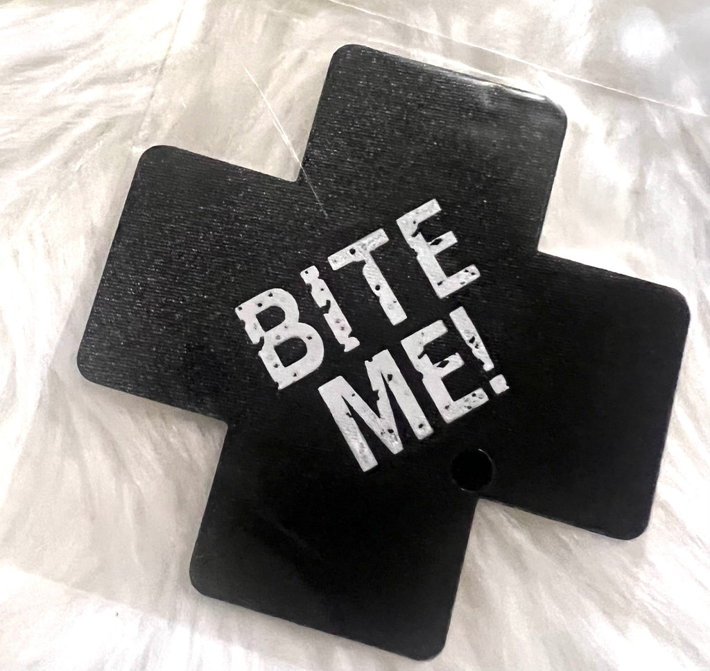 “Bite me” cross nipple covers